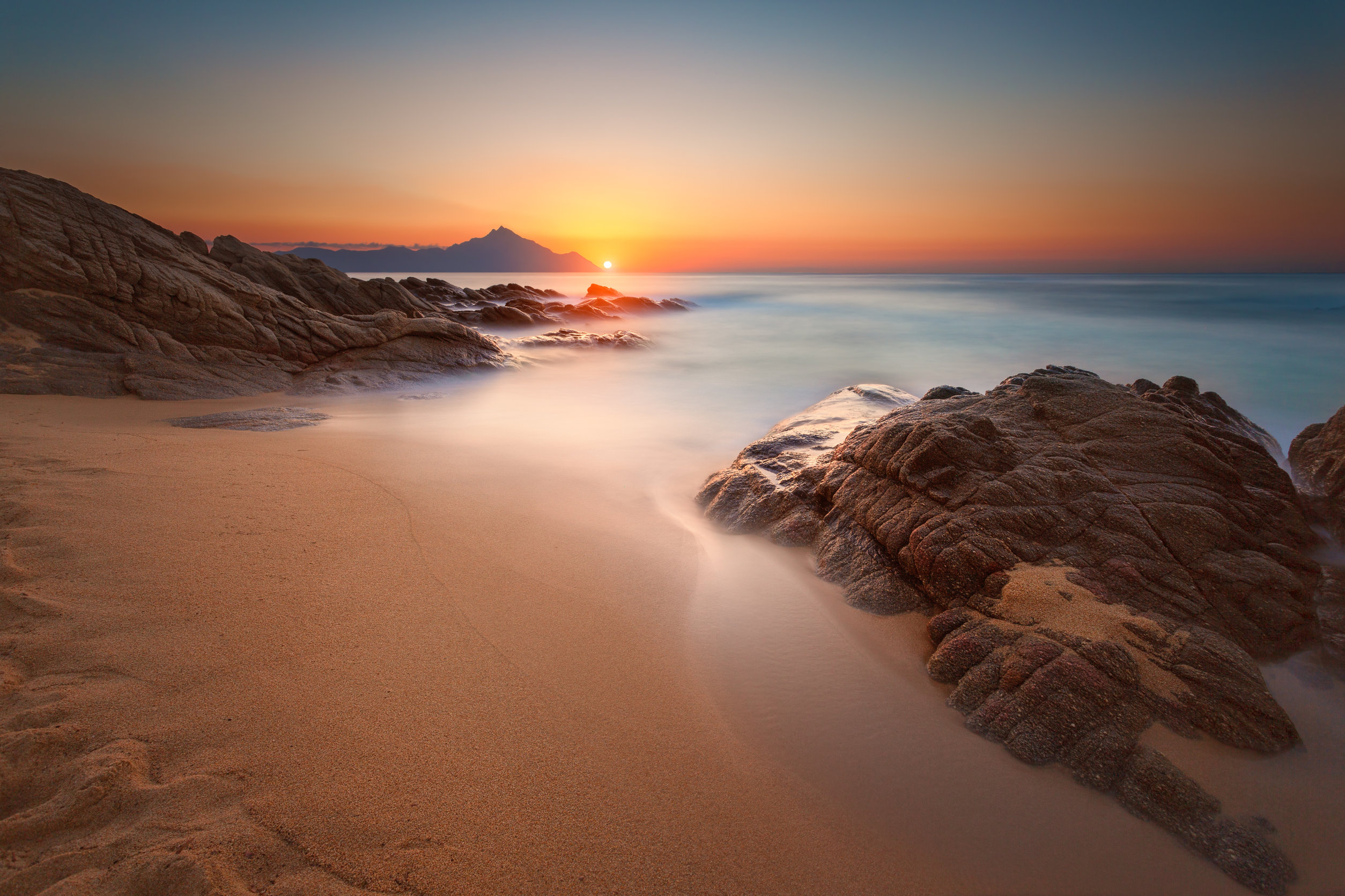 A rocky beach at sunset